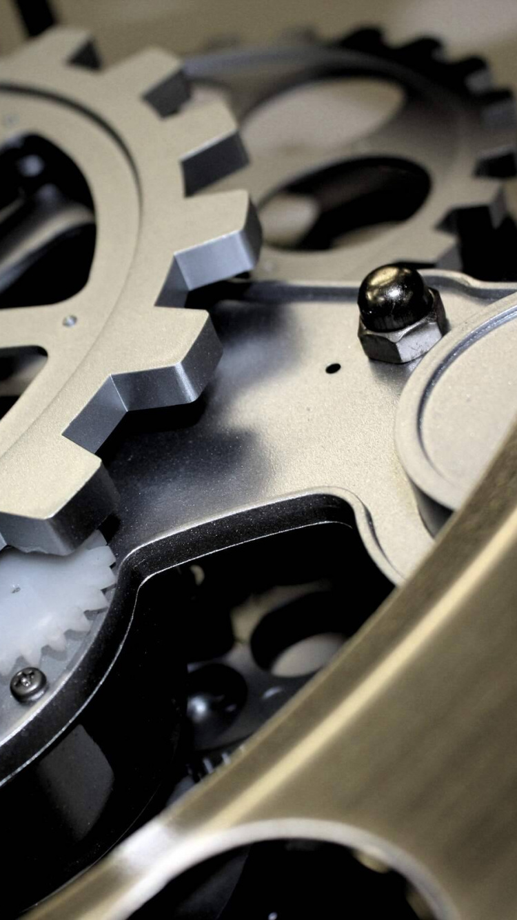 Black and Gold Round Metal Tool. Wallpaper in 750x1334 Resolution