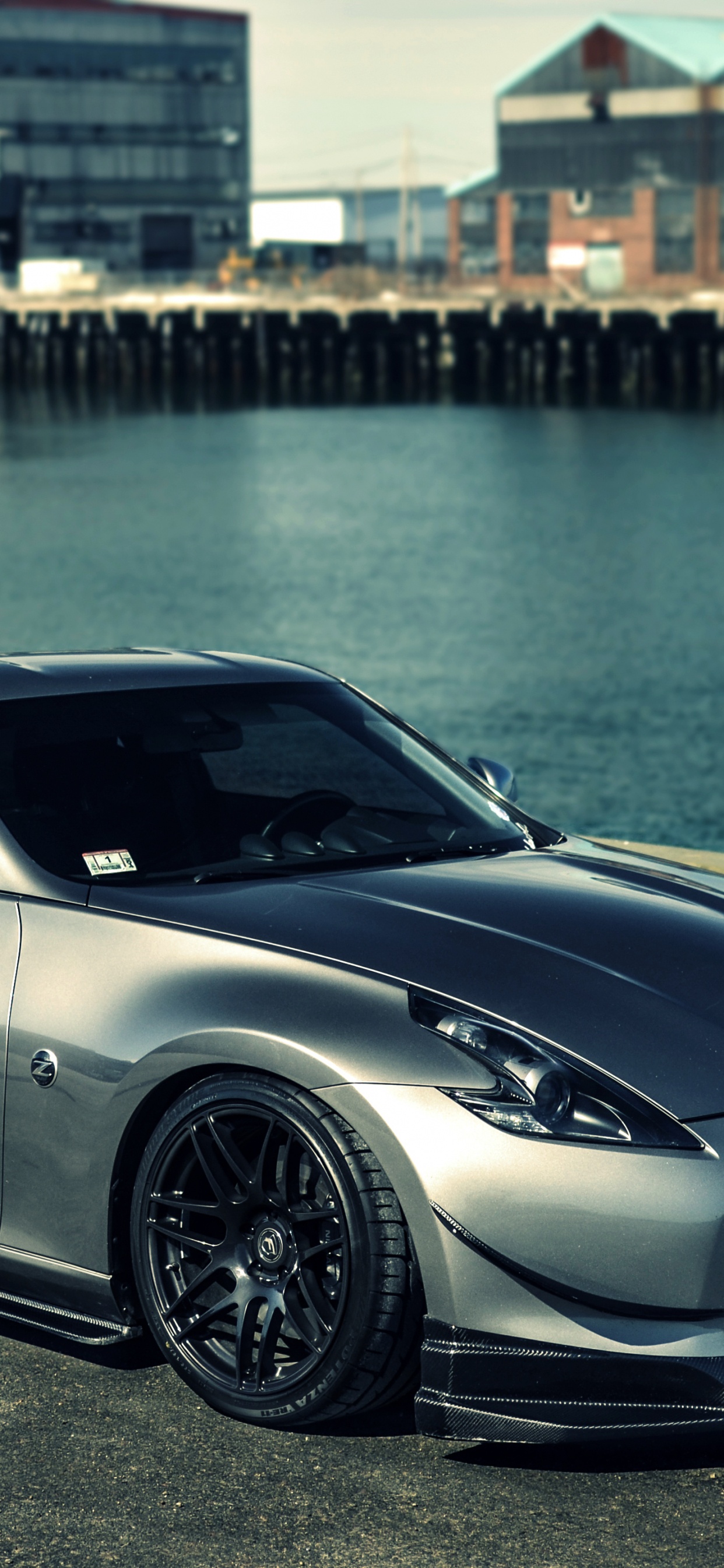 Silver Porsche 911 Estacionado Cerca Del Cuerpo de Agua Durante el Día. Wallpaper in 1242x2688 Resolution