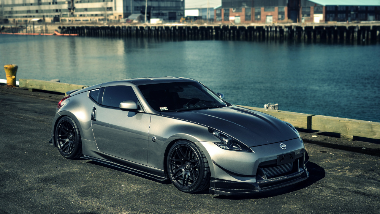 Silver Porsche 911 Parked Near Body of Water During Daytime. Wallpaper in 1280x720 Resolution