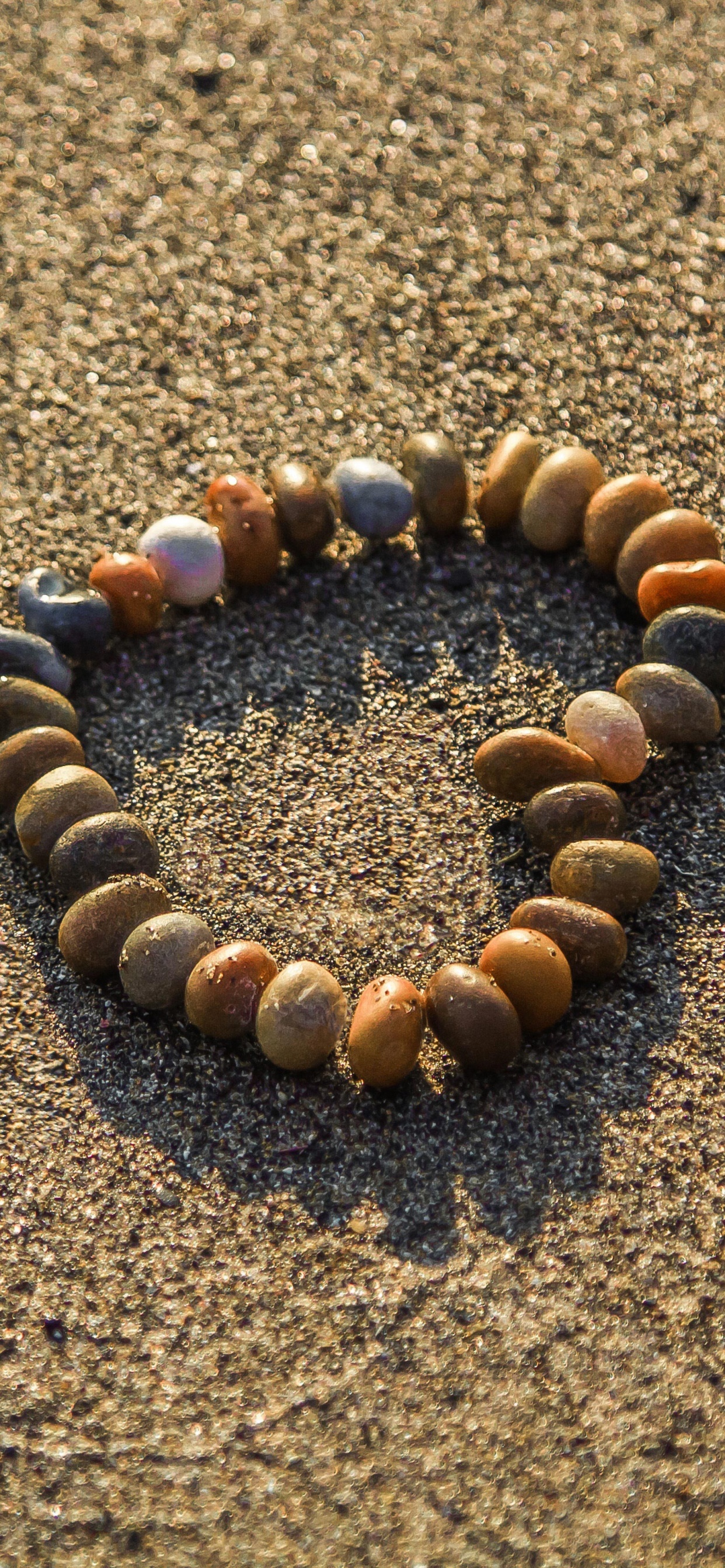 Brown and Black Stones on Brown Sand. Wallpaper in 1242x2688 Resolution