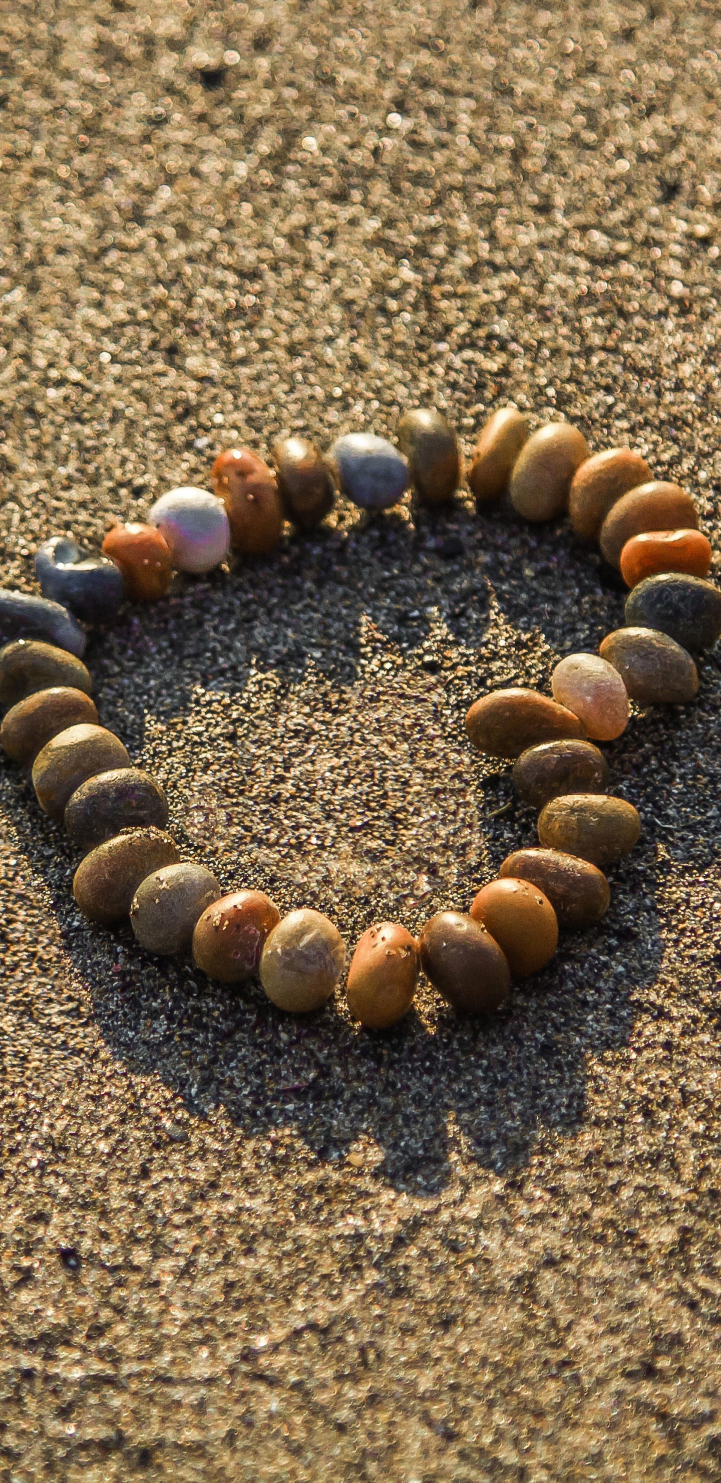 Brown and Black Stones on Brown Sand. Wallpaper in 1440x2960 Resolution