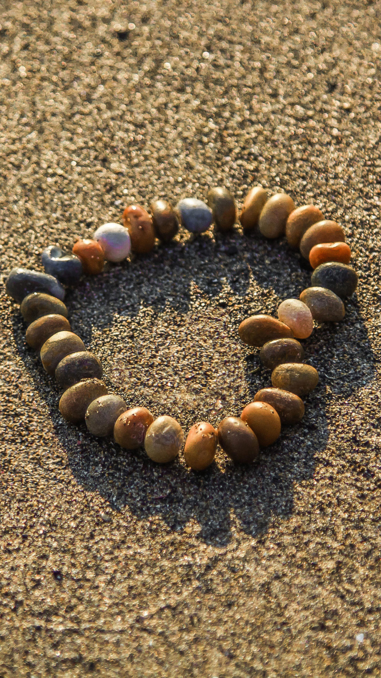 Brown and Black Stones on Brown Sand. Wallpaper in 750x1334 Resolution