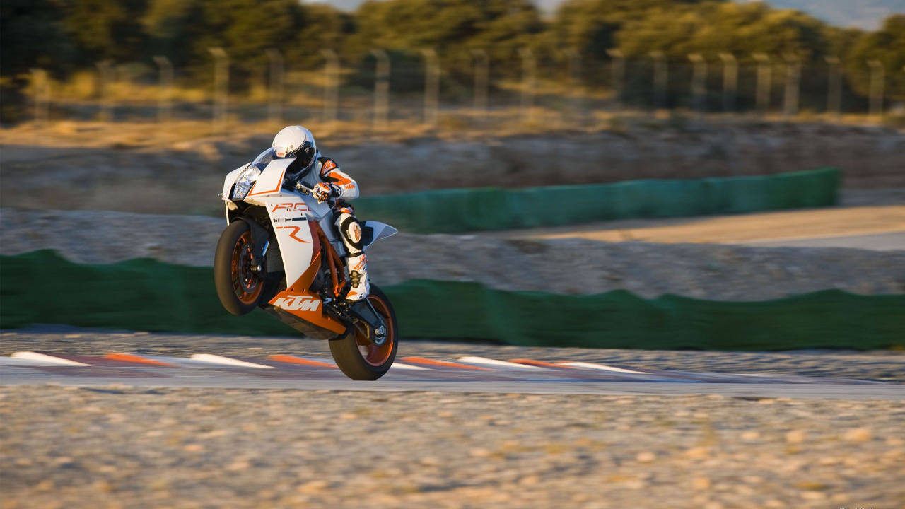Man Riding Orange and White Sports Bike on Road During Daytime. Wallpaper in 1280x720 Resolution