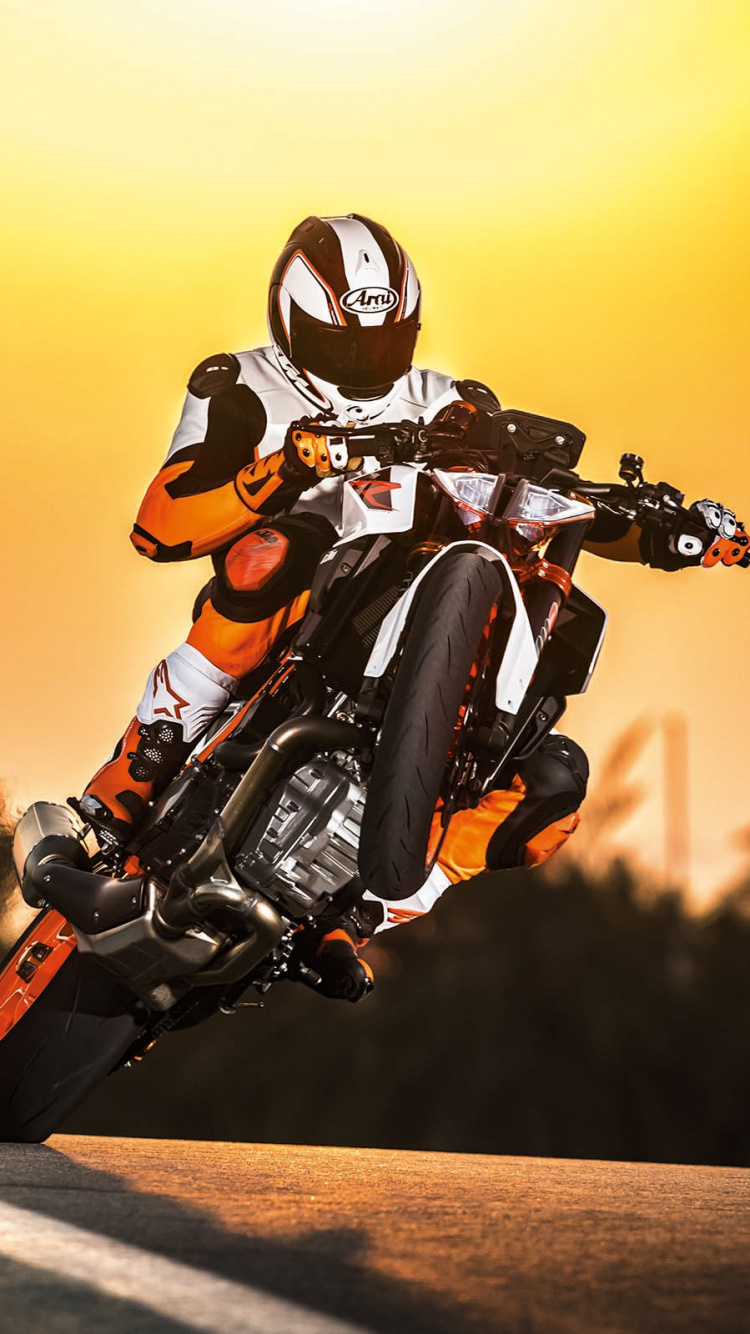 Man in Orange Helmet Riding Orange and Black Motorcycle. Wallpaper in 750x1334 Resolution