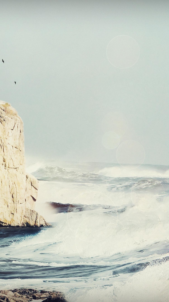 White Lighthouse on Brown Rock Formation Near Sea During Daytime. Wallpaper in 720x1280 Resolution