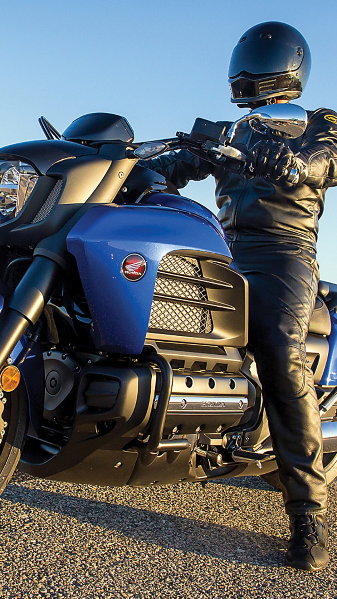 Man in Black Leather Jacket and Black Pants Riding Blue and Black Motorcycle. Wallpaper in 1080x1920 Resolution