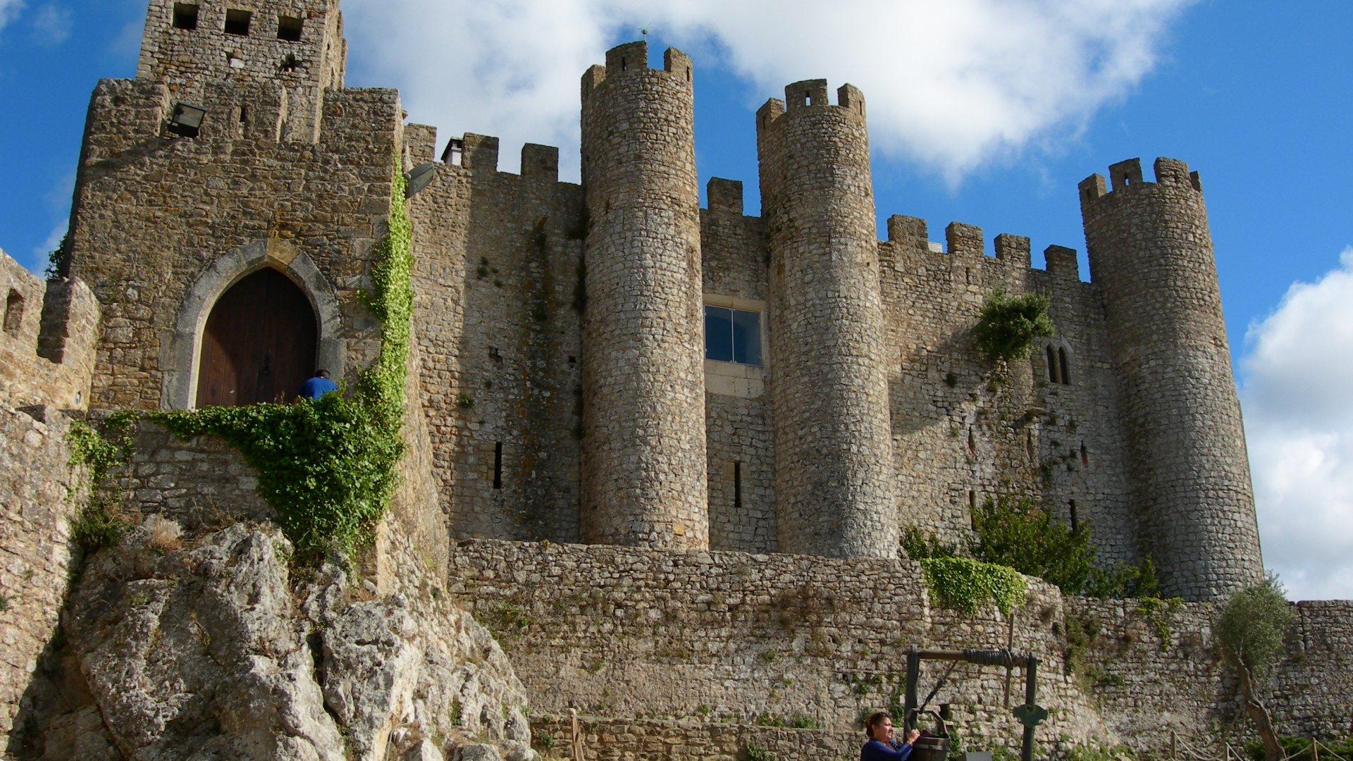 Woman in Red Jacket Standing on Rock Formation During Daytime. Wallpaper in 1920x1080 Resolution