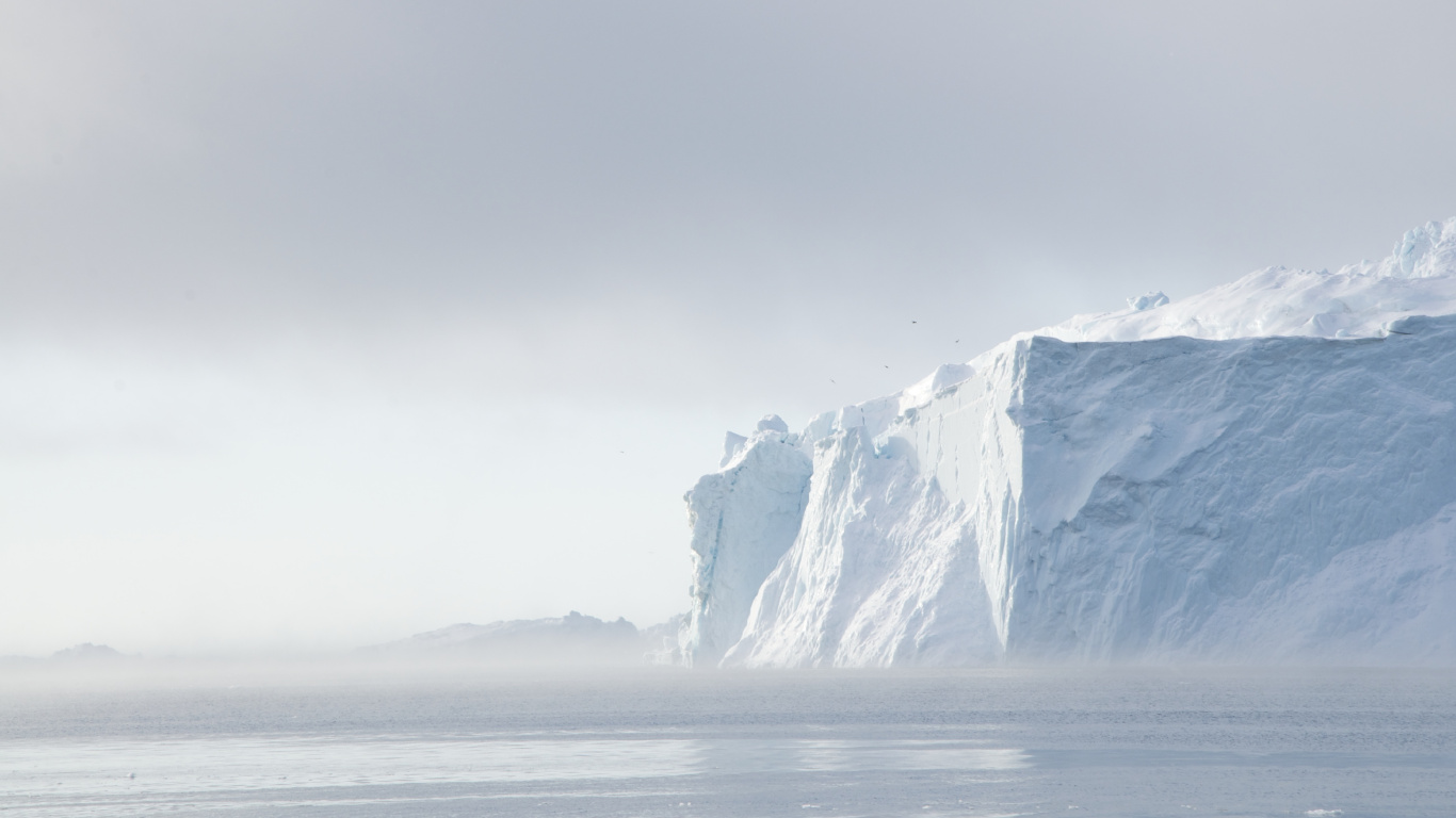 Snow Covered Mountain Near Body of Water During Daytime. Wallpaper in 1366x768 Resolution