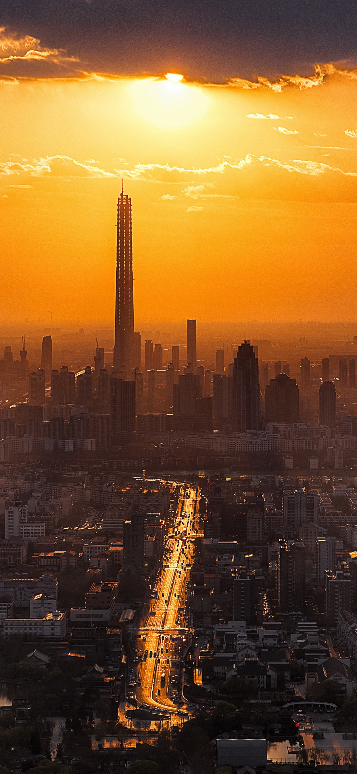 City Skyline During Sunset With Body of Water. Wallpaper in 1242x2688 Resolution