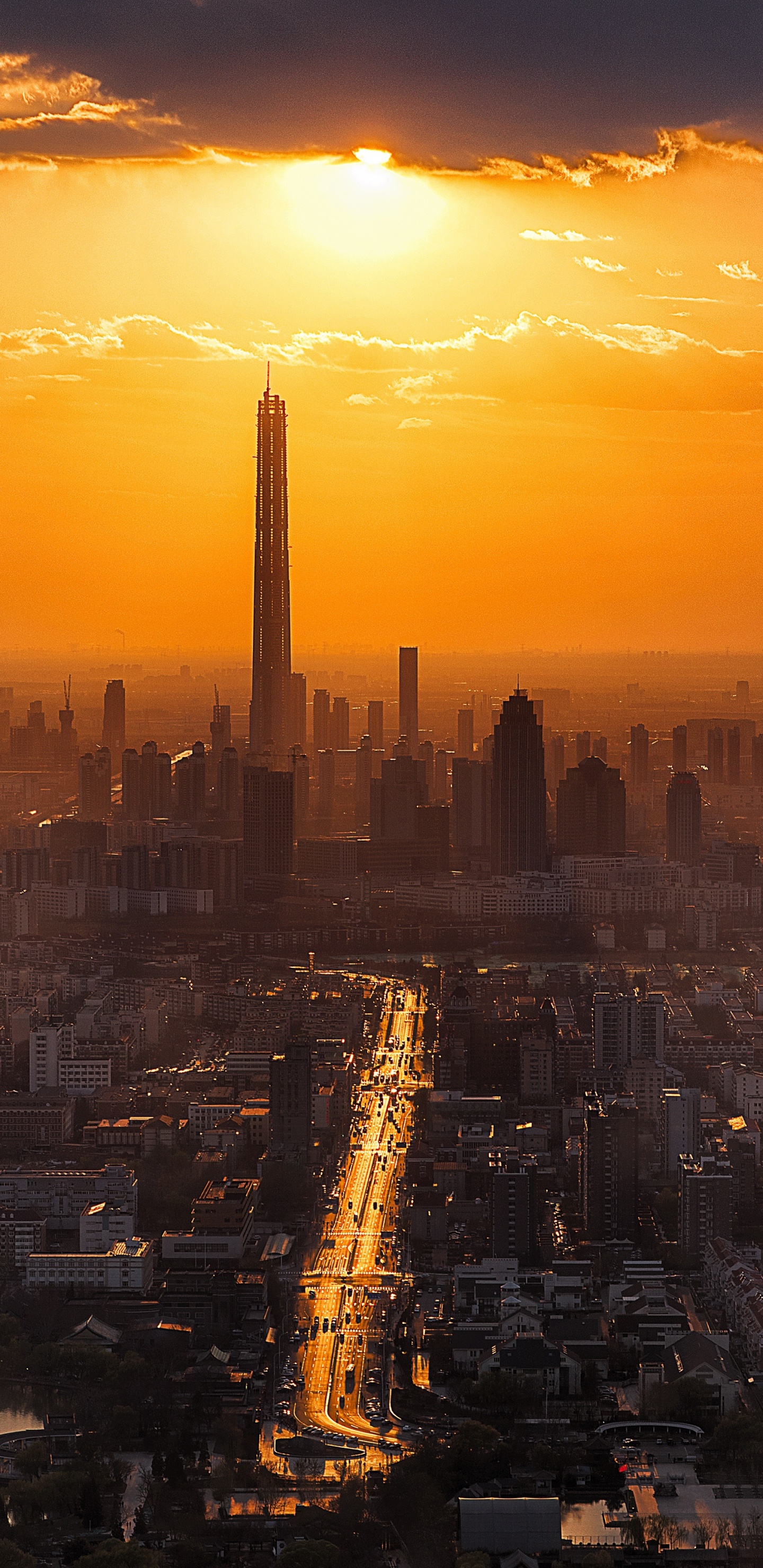 City Skyline During Sunset With Body of Water. Wallpaper in 1440x2960 Resolution