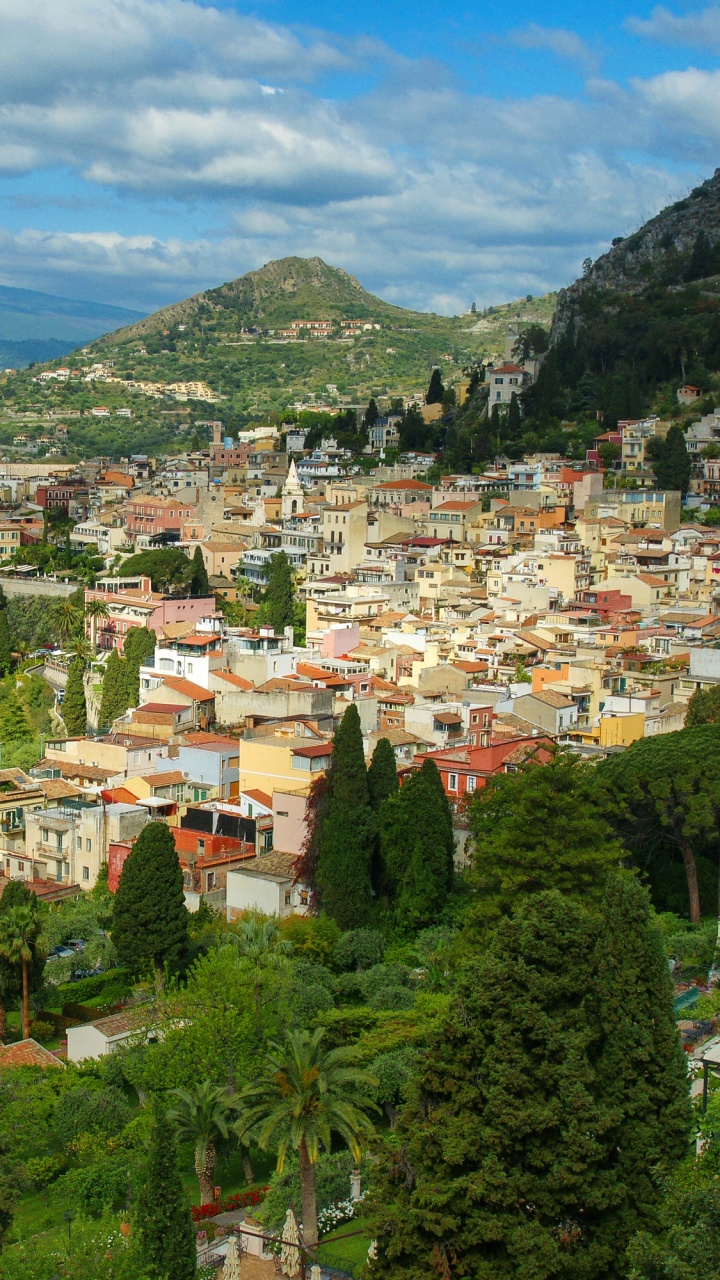 White and Brown Houses on Green Mountain Under Blue Sky During Daytime. Wallpaper in 720x1280 Resolution