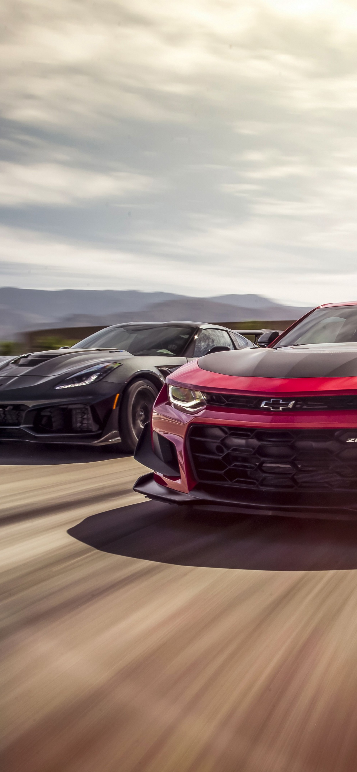 Red Chevrolet Camaro on Road. Wallpaper in 1242x2688 Resolution