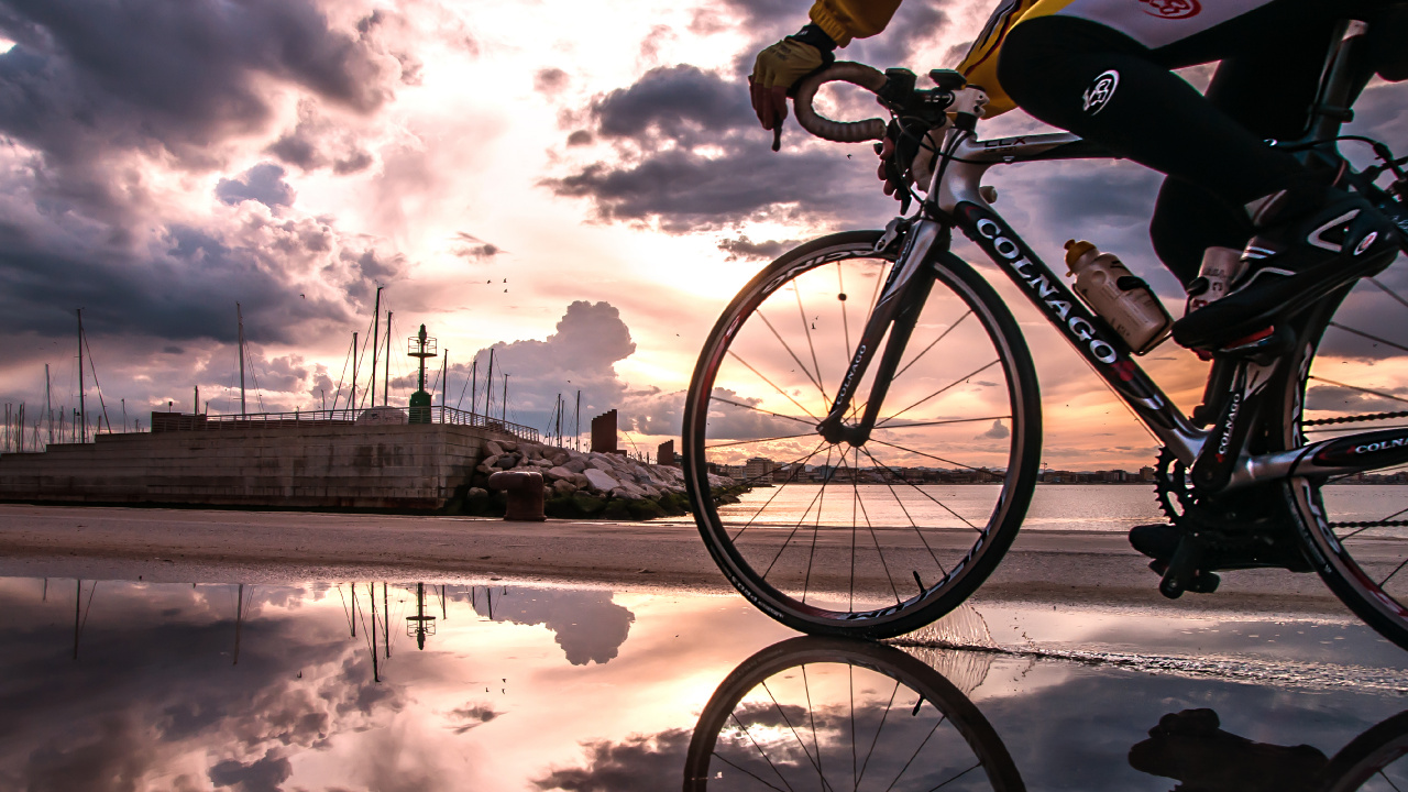 Black and White Bicycle on Snow Covered Ground Near Body of Water During Daytime. Wallpaper in 1280x720 Resolution