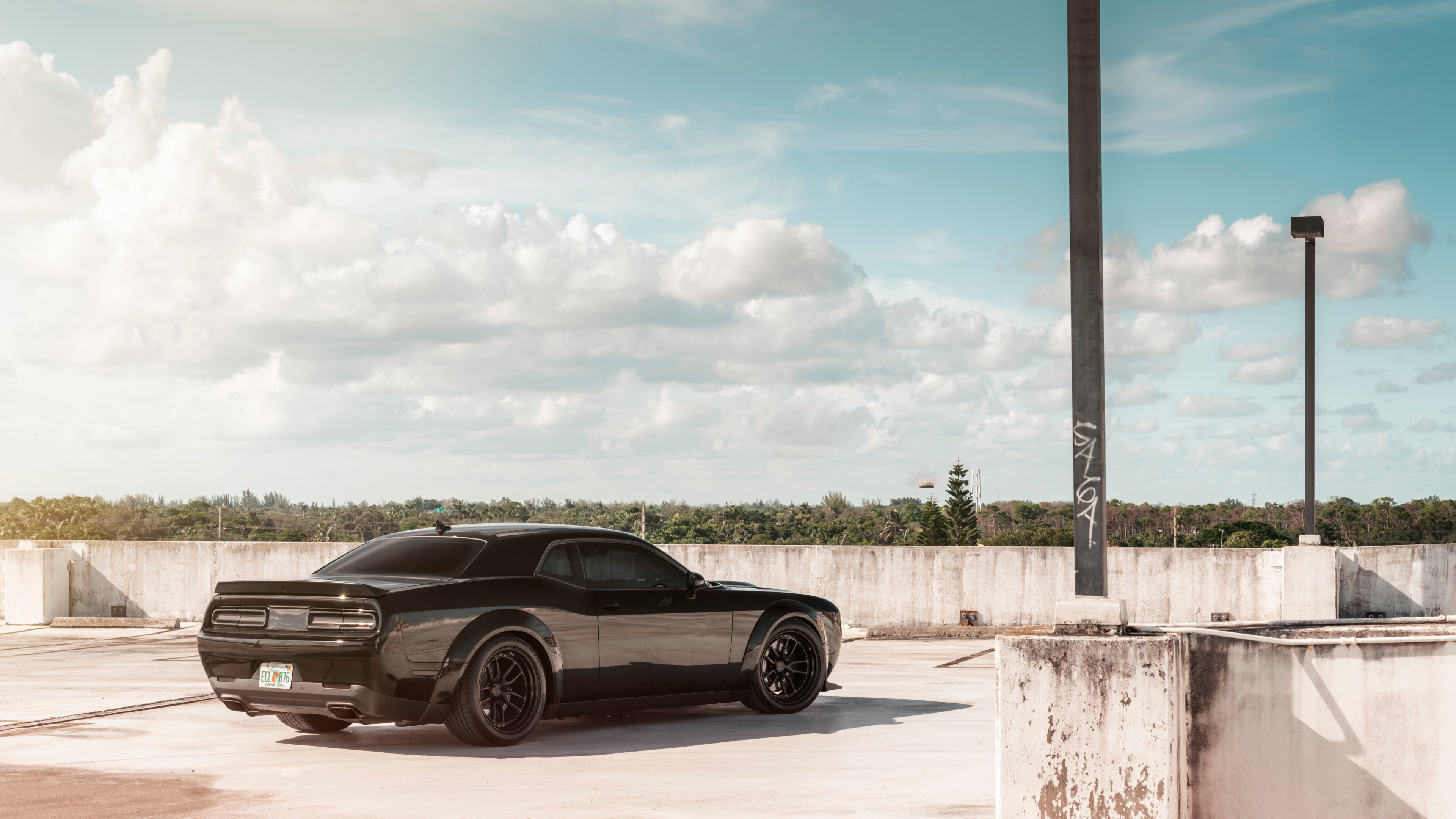 Black Coupe Parked Beside Gray Wooden Fence During Daytime. Wallpaper in 3840x2160 Resolution