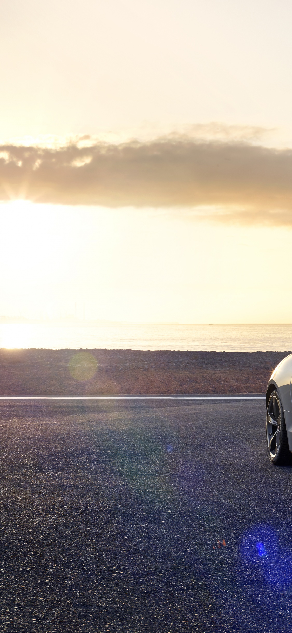White Porsche 911 on Beach During Sunset. Wallpaper in 1125x2436 Resolution