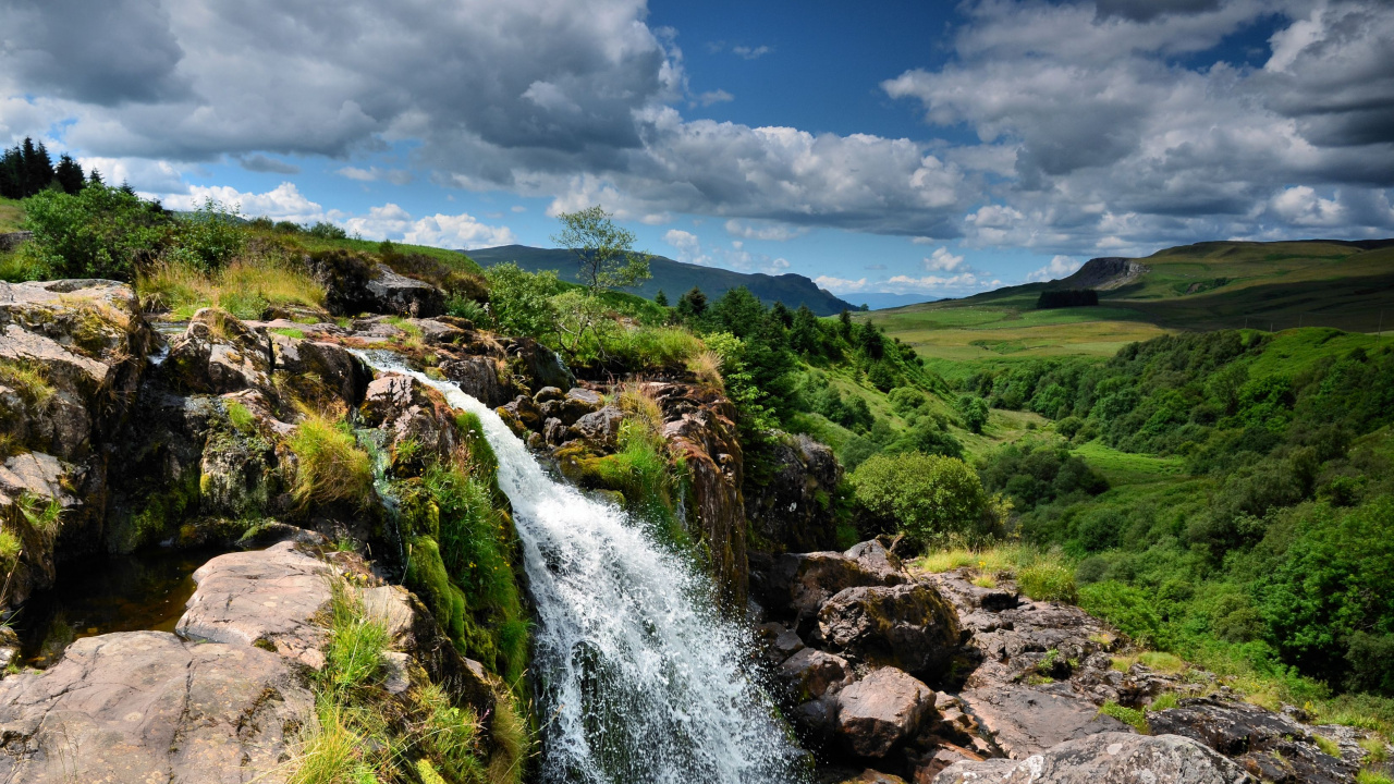 Water Falls on Green Grass Field Under White Clouds and Blue Sky During Daytime. Wallpaper in 1280x720 Resolution