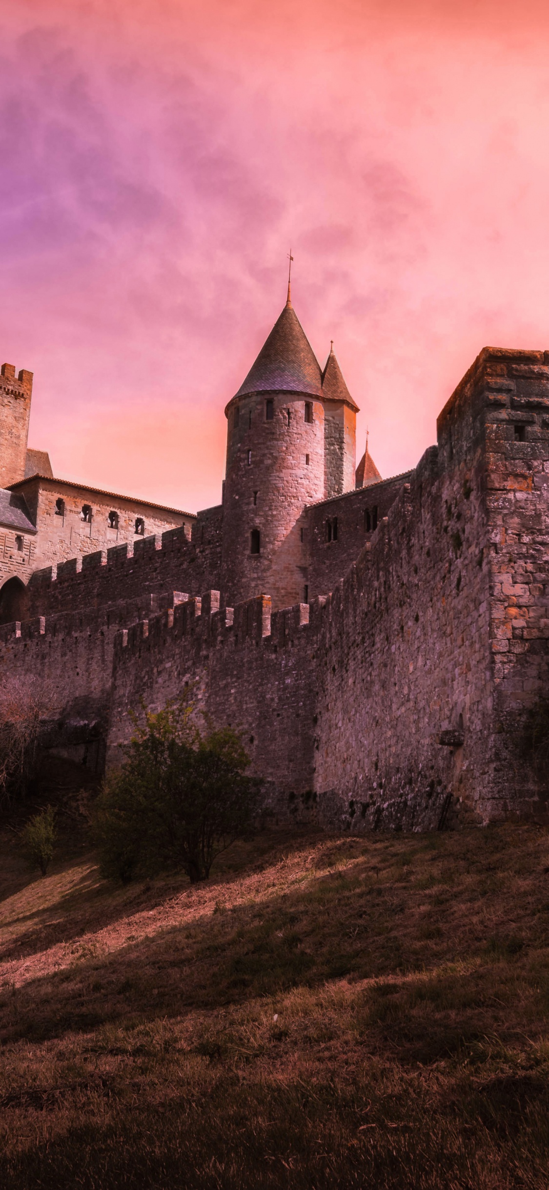 Gray Concrete Castle Under Cloudy Sky. Wallpaper in 1125x2436 Resolution