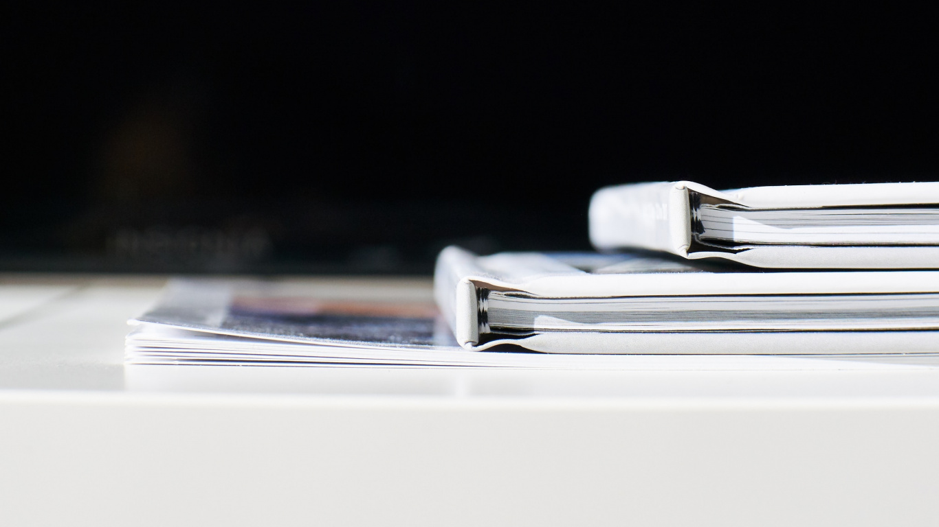 White Printer Paper on White Table. Wallpaper in 1366x768 Resolution