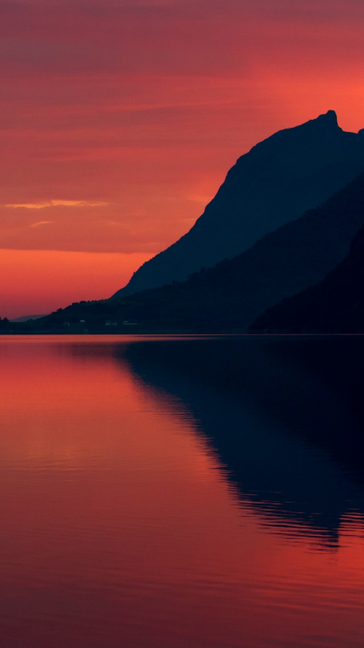 Silhouette of Mountain Near Body of Water During Sunset. Wallpaper in 720x1280 Resolution