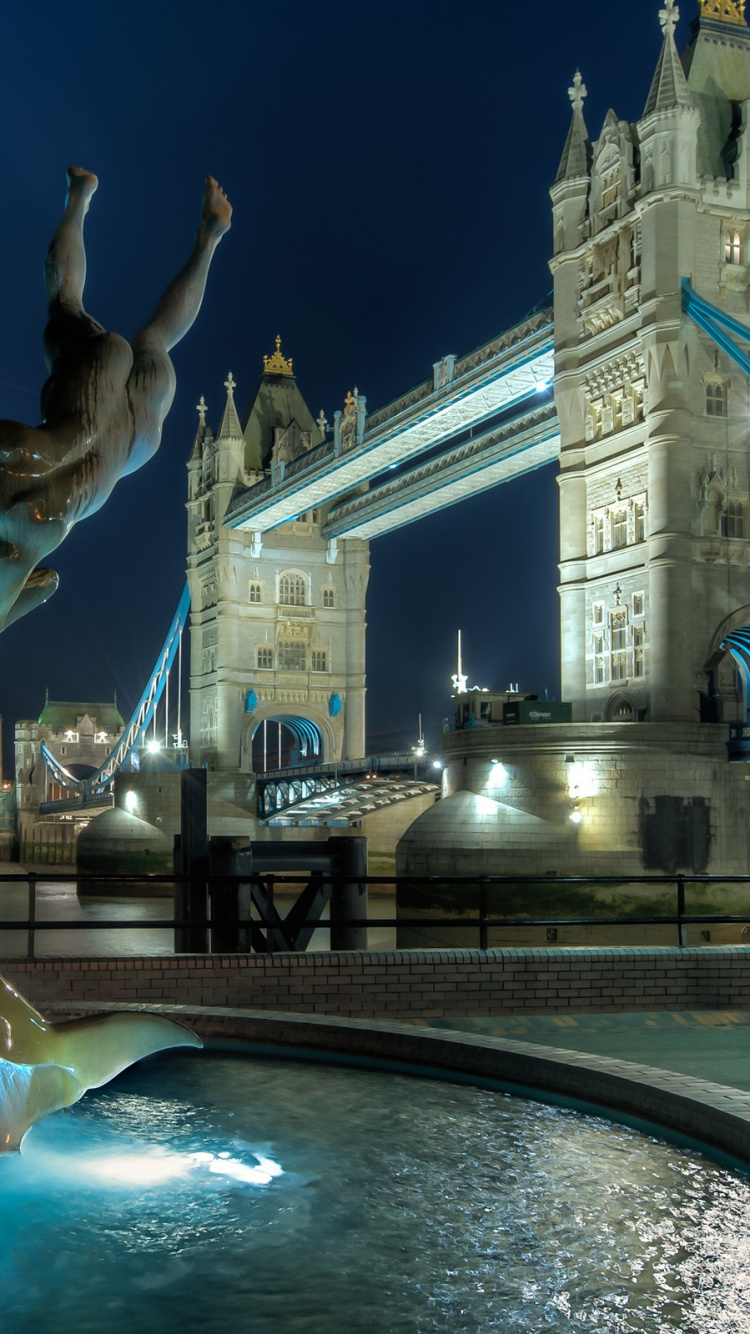 Fountain in Front of White Concrete Building During Night Time. Wallpaper in 750x1334 Resolution