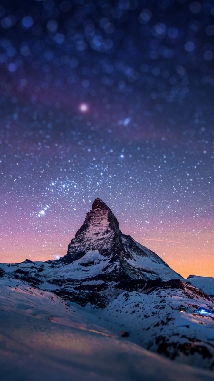 Snow Covered Mountain Under Starry Night. Wallpaper in 720x1280 Resolution
