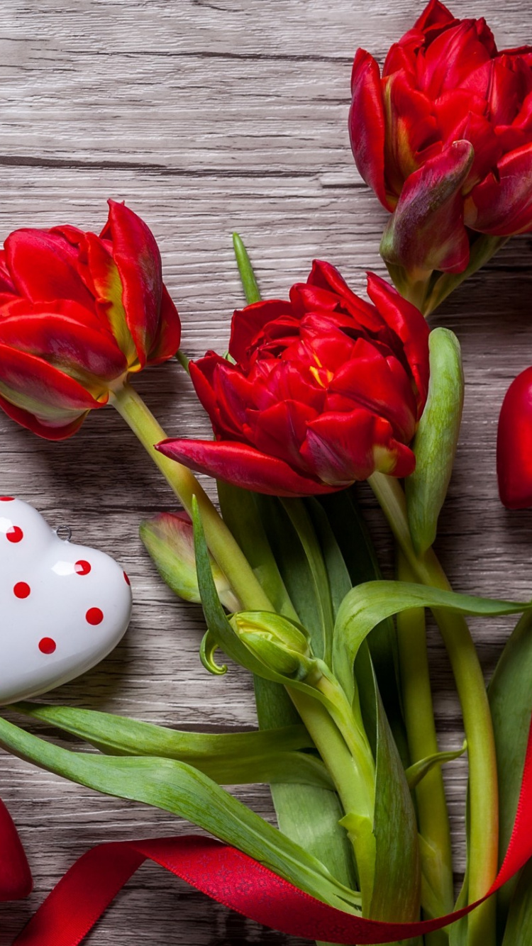 Red and White Ceramic Dice Beside Red Tulips. Wallpaper in 750x1334 Resolution