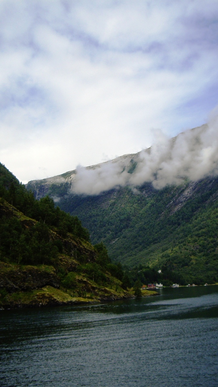 Green Mountain Beside Body of Water Under Cloudy Sky During Daytime. Wallpaper in 720x1280 Resolution