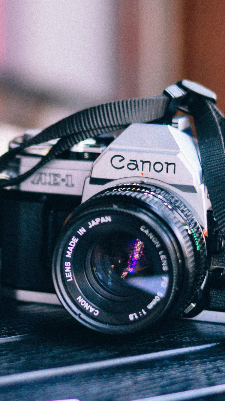 Black Nikon Dslr Camera on Brown Wooden Table. Wallpaper in 750x1334 Resolution