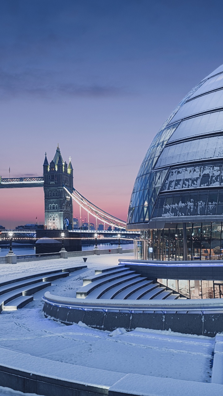 People Walking on Gray Concrete Pavement Near Glass Building During Night Time. Wallpaper in 720x1280 Resolution