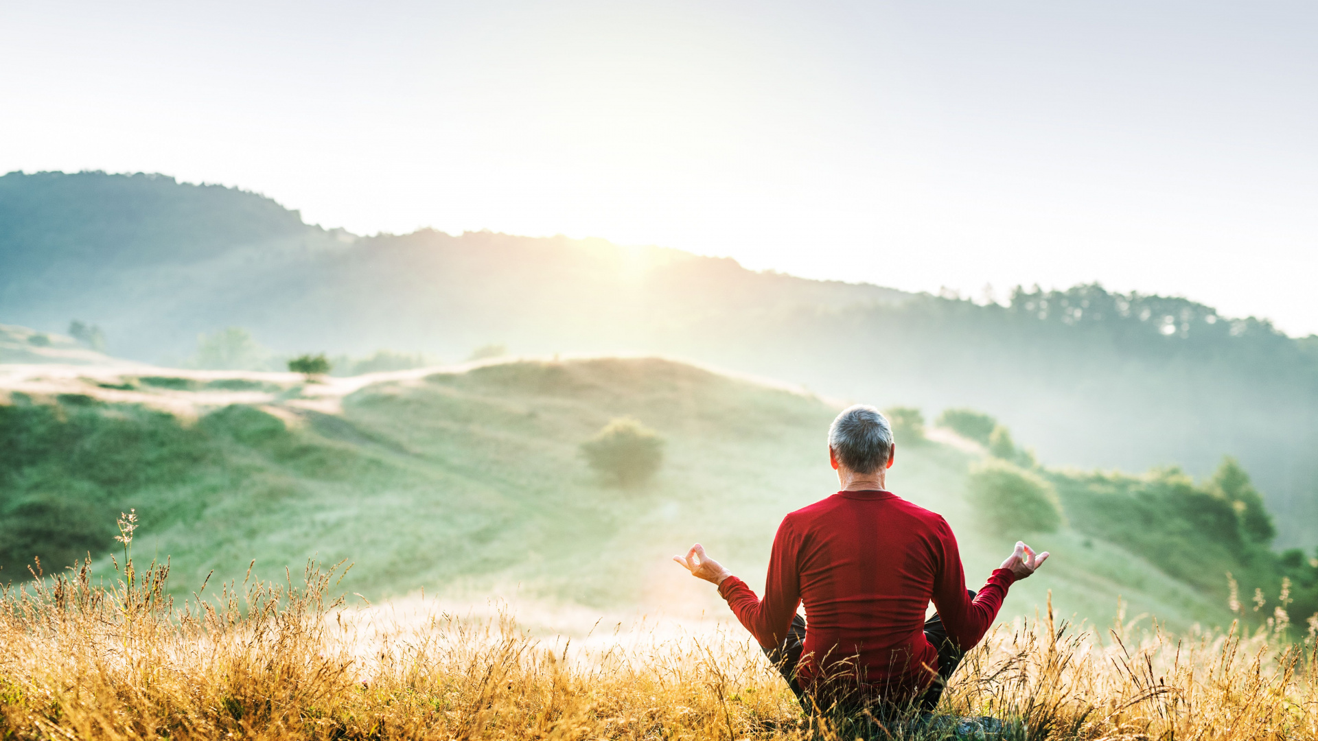 Man in Red and Black Striped Long Sleeve Shirt Sitting on Brown Grass Field During Daytime. Wallpaper in 1920x1080 Resolution