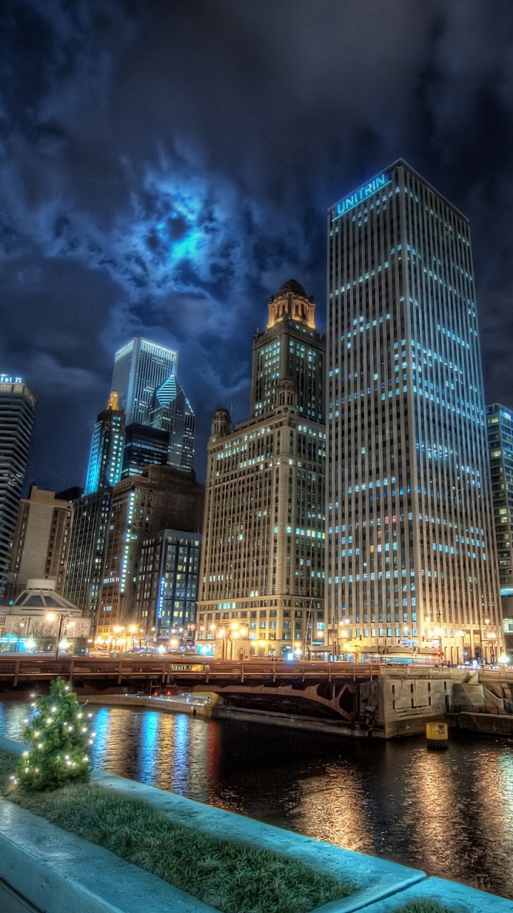 City Skyline Across Body of Water During Night Time. Wallpaper in 720x1280 Resolution