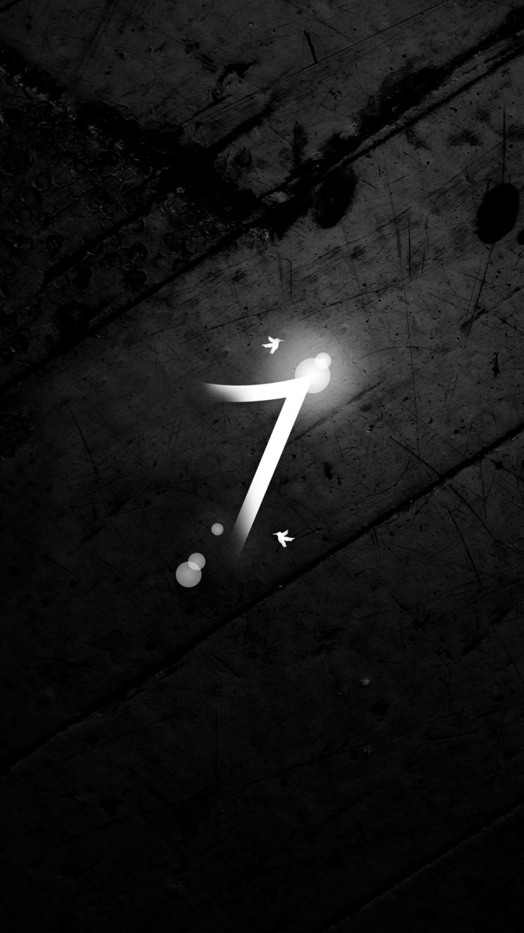 White Light Bulb on Black Surface. Wallpaper in 750x1334 Resolution