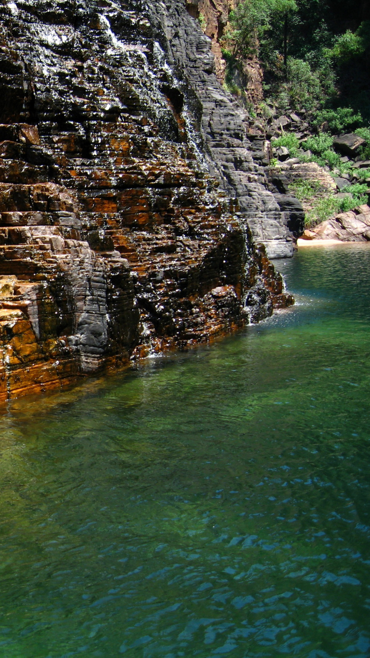 Brown and Gray Rock Formation on Body of Water During Daytime. Wallpaper in 750x1334 Resolution