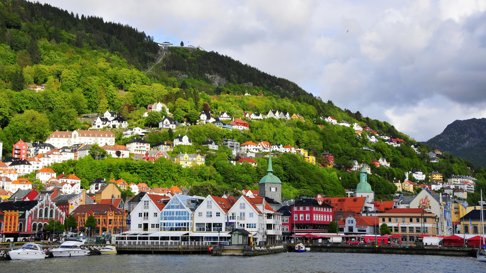 White and Brown Houses Near Green Mountain Under White Clouds During Daytime. Wallpaper in 1920x1080 Resolution
