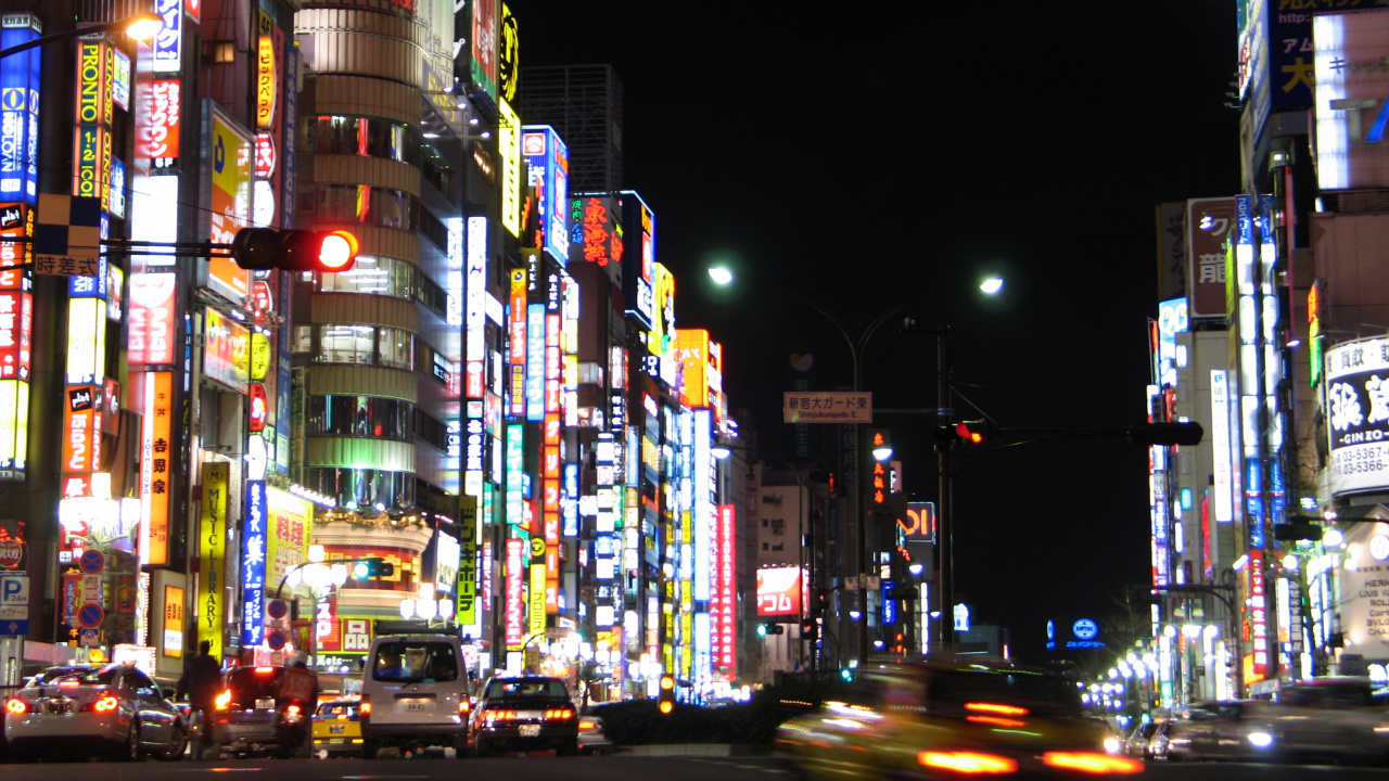 Cars on Road Between High Rise Buildings During Night Time. Wallpaper in 1280x720 Resolution