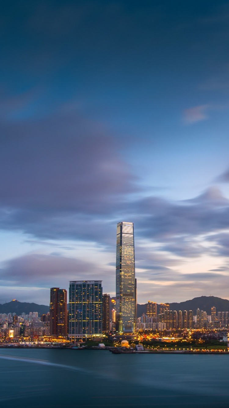 City Skyline Near Body of Water During Night Time. Wallpaper in 750x1334 Resolution