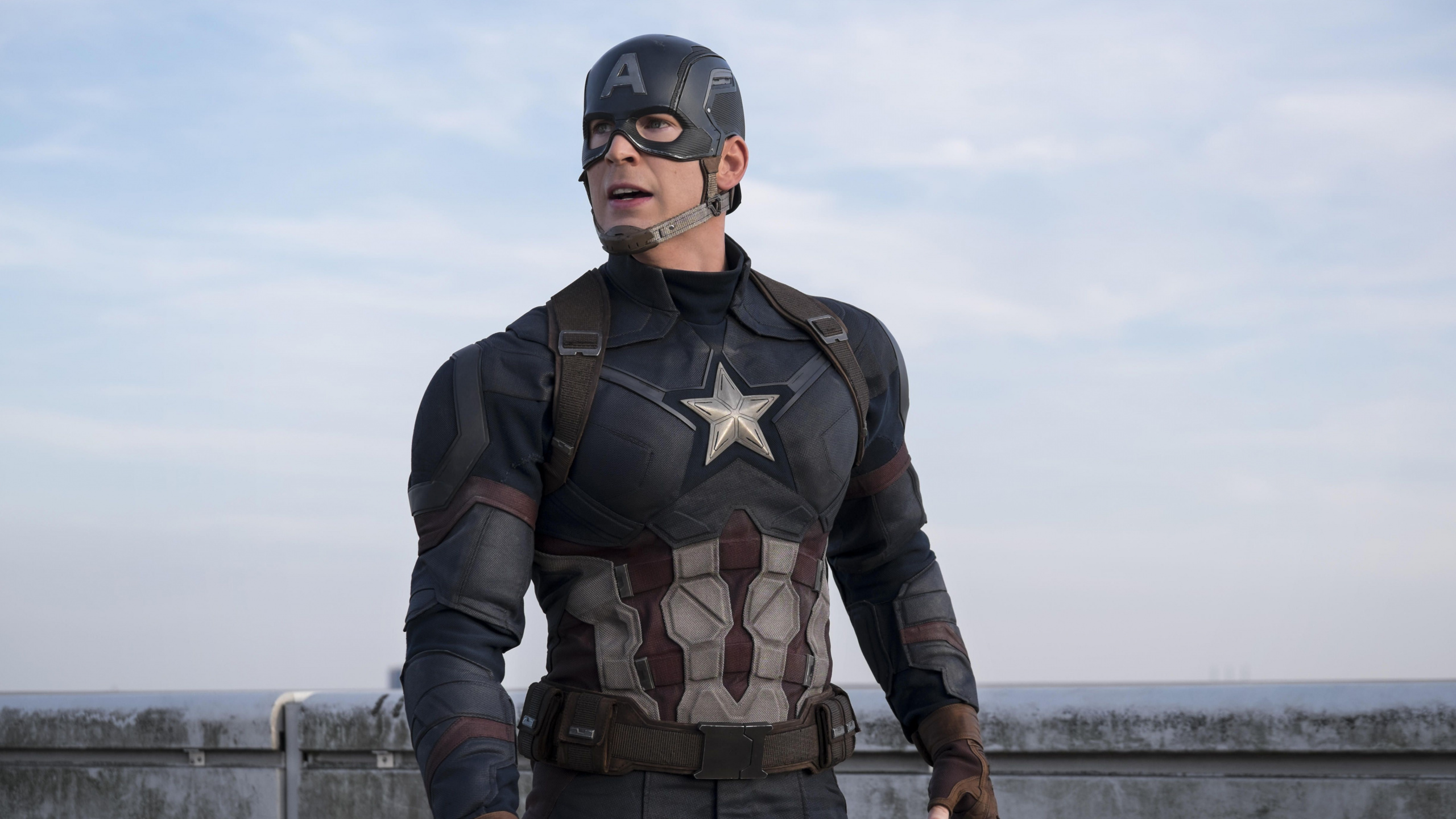 Man in Black and Brown Camouflage Suit Standing on Dock During Daytime. Wallpaper in 2560x1440 Resolution