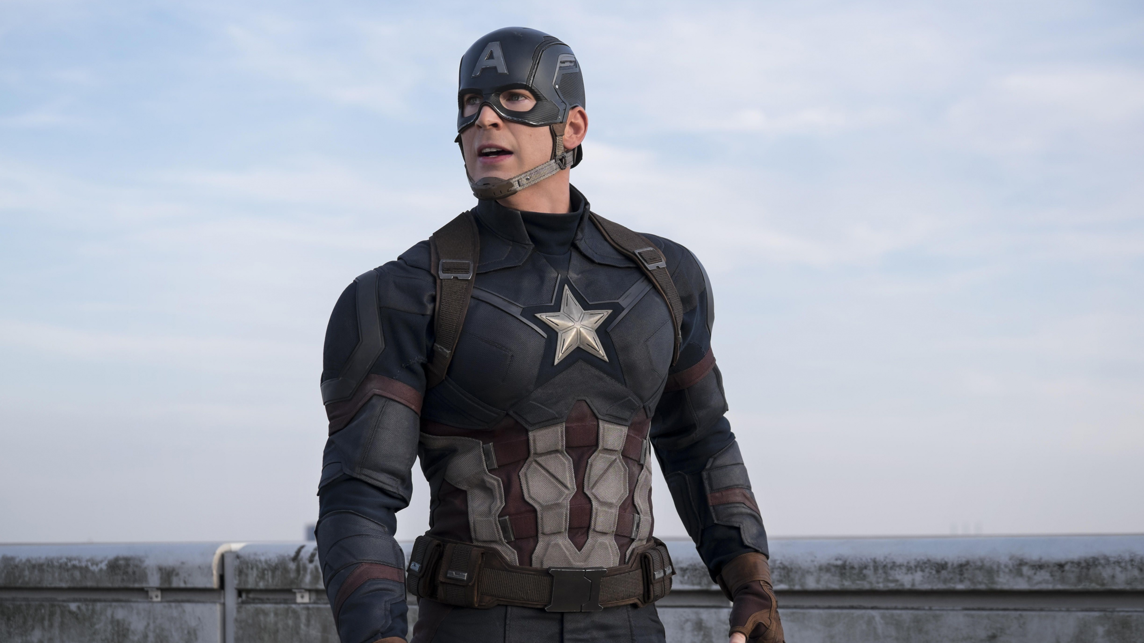 L'homme en Costume de Camouflage Noir et Marron Debout Sur le Quai Pendant la Journée. Wallpaper in 3840x2160 Resolution