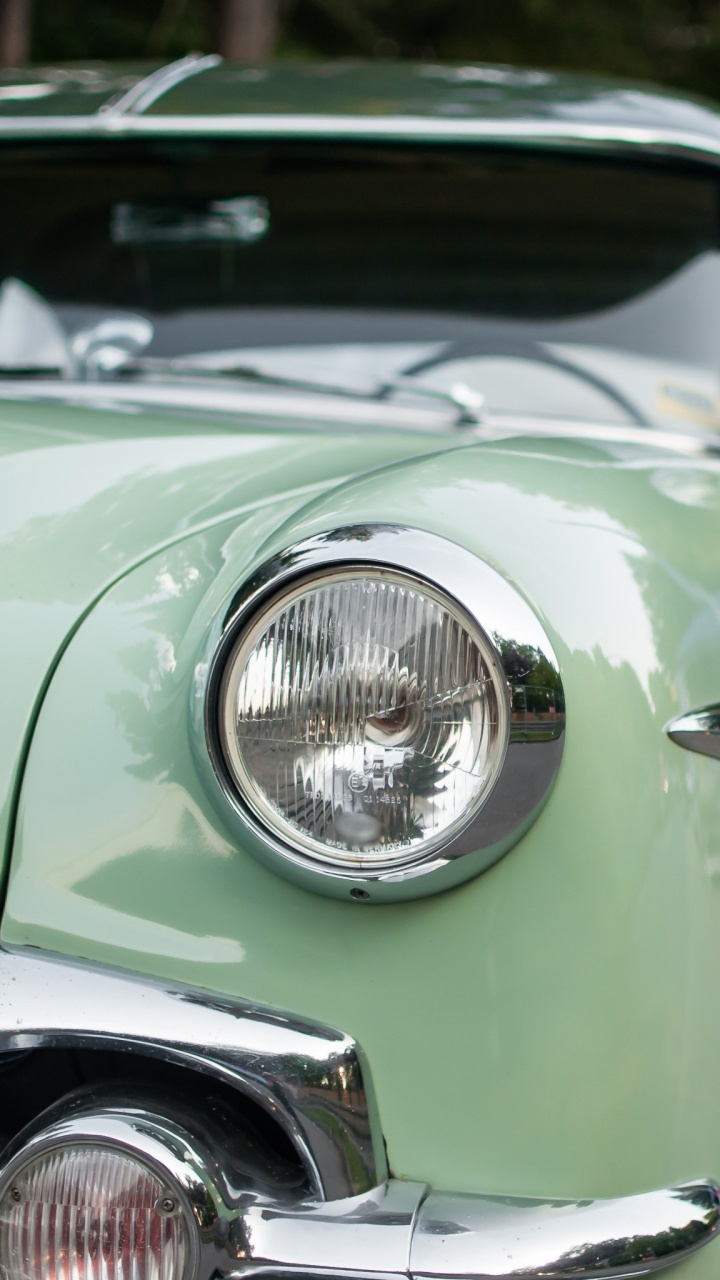 Green Car With Chrome Headlight. Wallpaper in 720x1280 Resolution