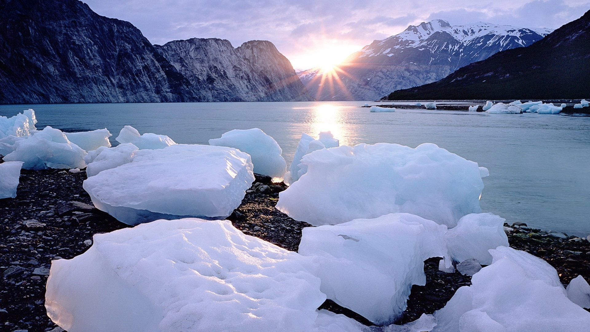 Snow Covered Rocks Near Body of Water During Daytime. Wallpaper in 1920x1080 Resolution