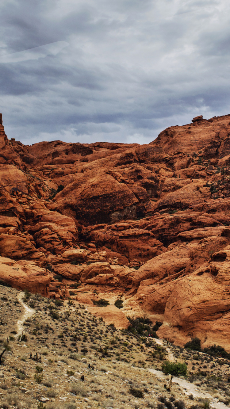 Brown Rocky Mountain Under Cloudy Sky During Daytime. Wallpaper in 750x1334 Resolution