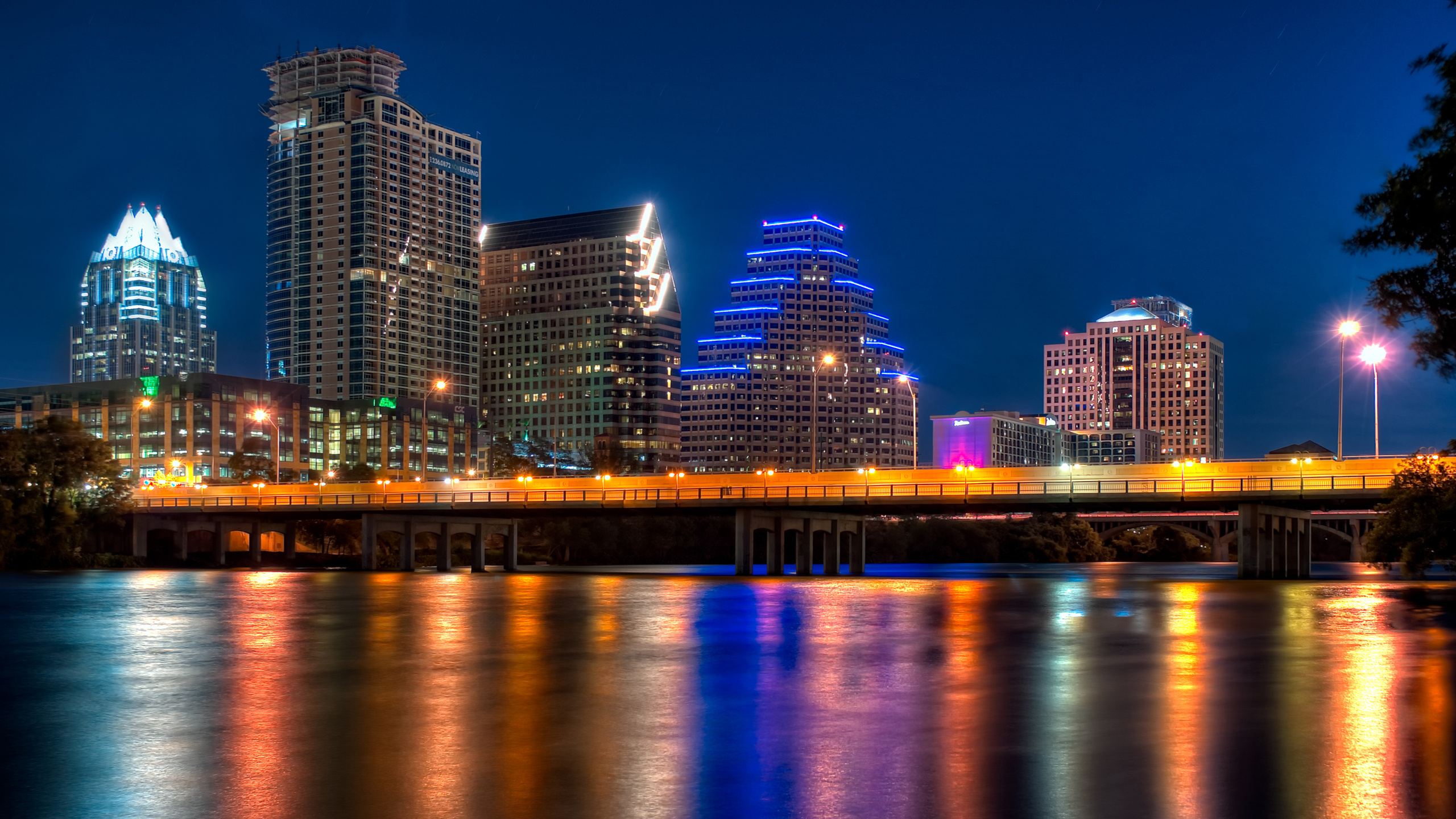 City Skyline Across Body of Water During Night Time. Wallpaper in 2560x1440 Resolution