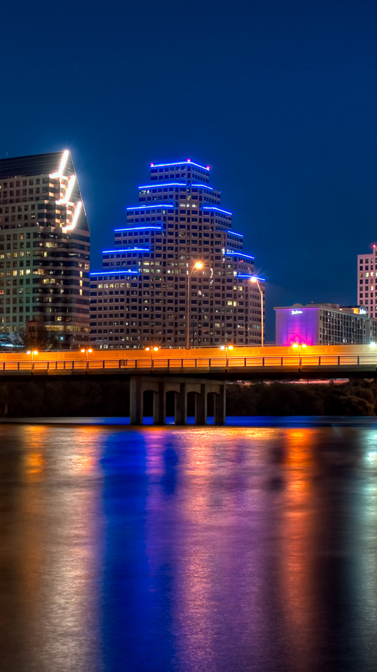 City Skyline Across Body of Water During Night Time. Wallpaper in 750x1334 Resolution