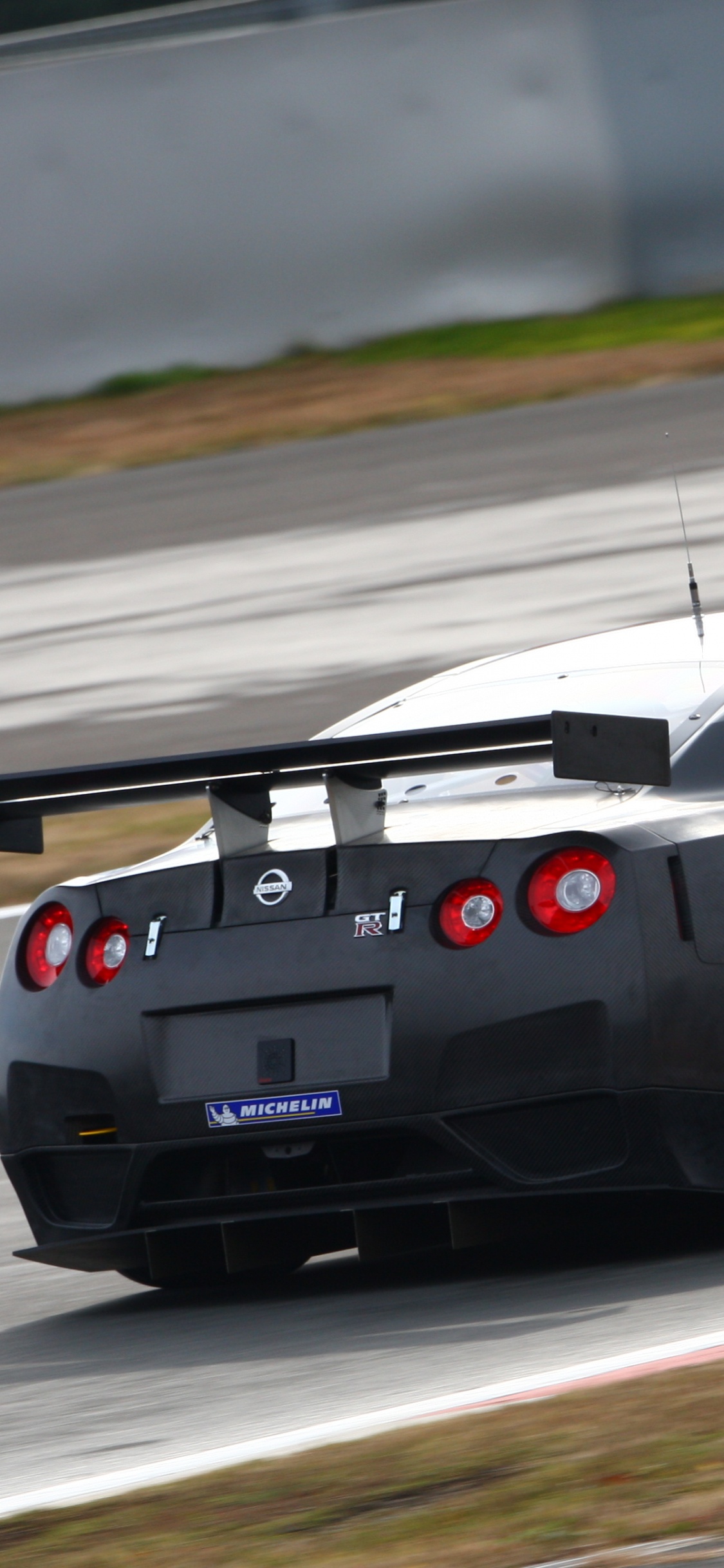 Black Porsche 911 on Road. Wallpaper in 1125x2436 Resolution