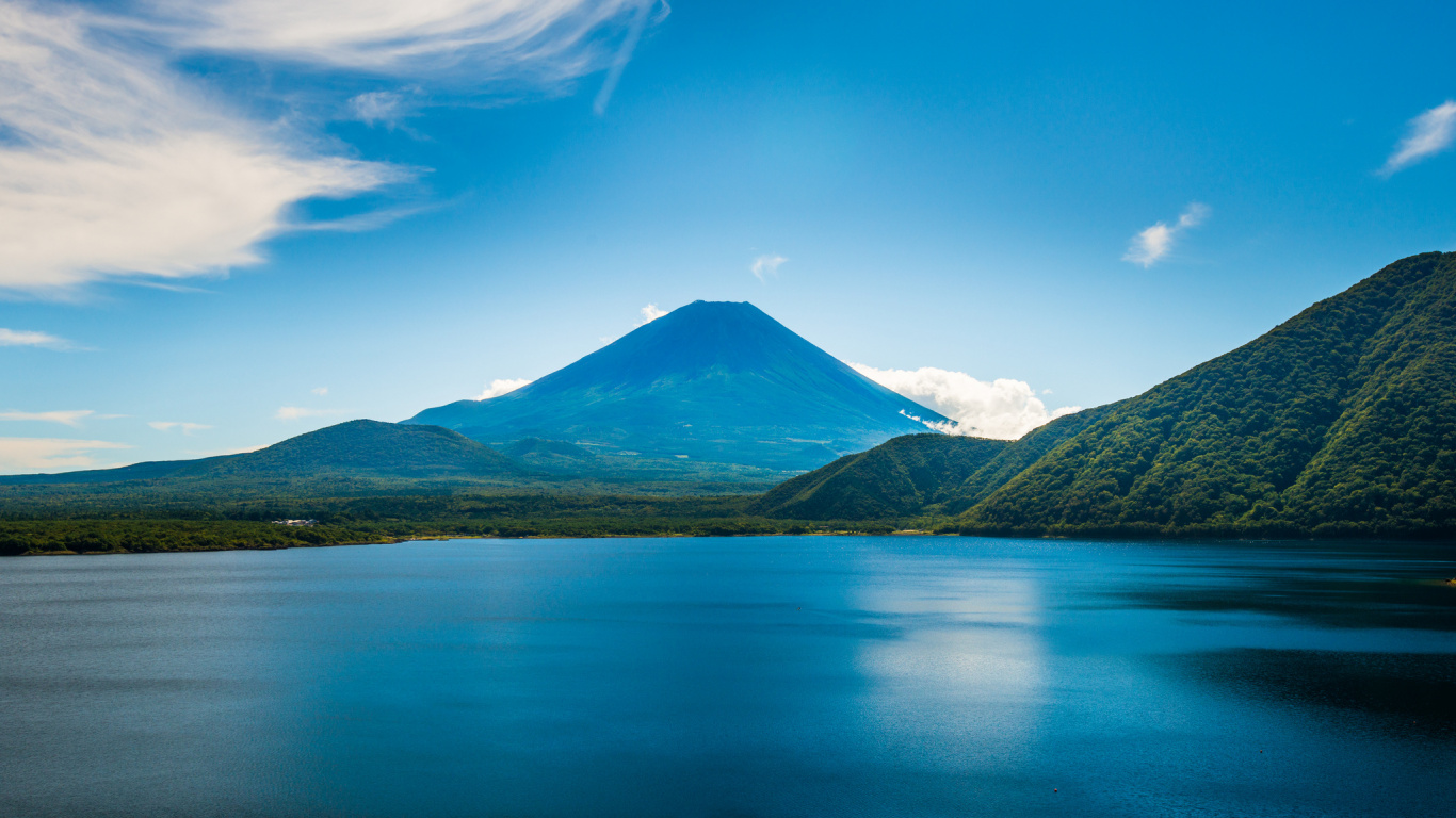 Blue Lake Near Green Mountain Under Blue Sky During Daytime. Wallpaper in 1366x768 Resolution