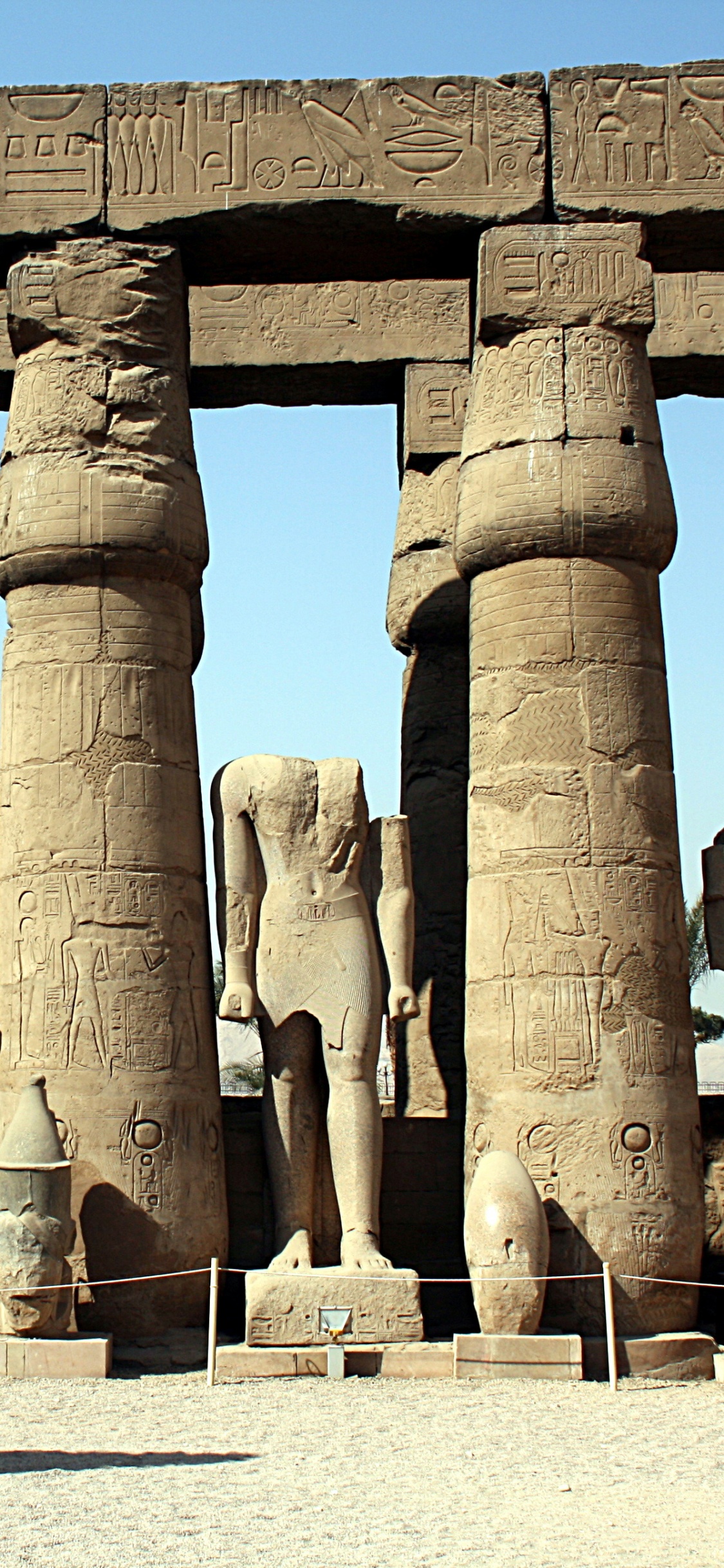 Brown Concrete Statues During Daytime. Wallpaper in 1125x2436 Resolution