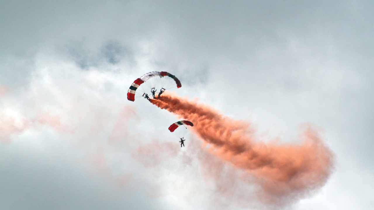 Person in Red Parachute Under White Clouds. Wallpaper in 1280x720 Resolution