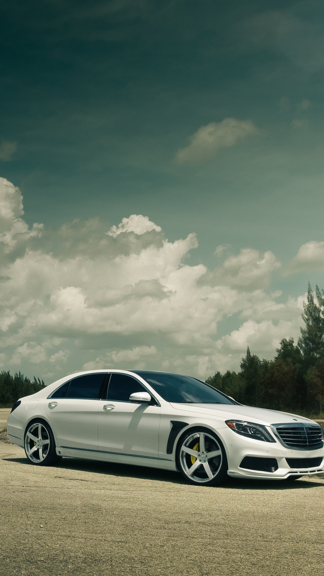 White Sedan on Gray Asphalt Road Under White Clouds and Blue Sky During Daytime. Wallpaper in 1080x1920 Resolution