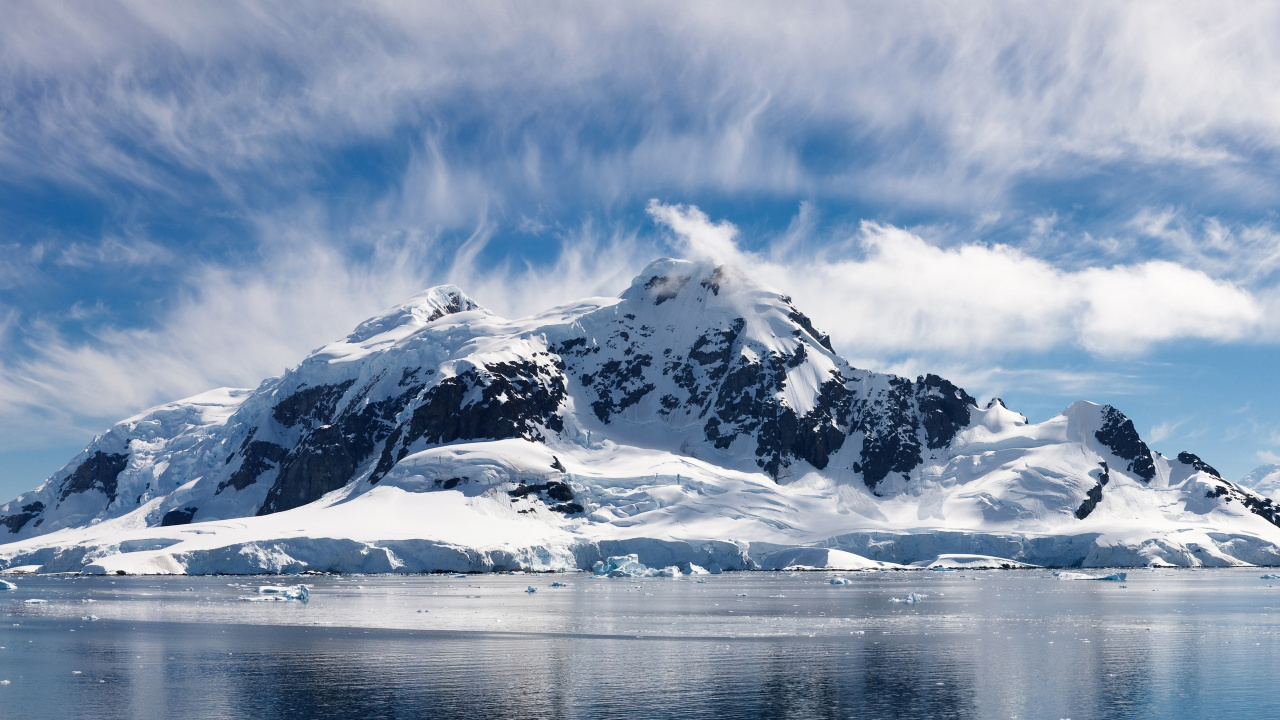 Snow Covered Mountain Near Body of Water During Daytime. Wallpaper in 1280x720 Resolution