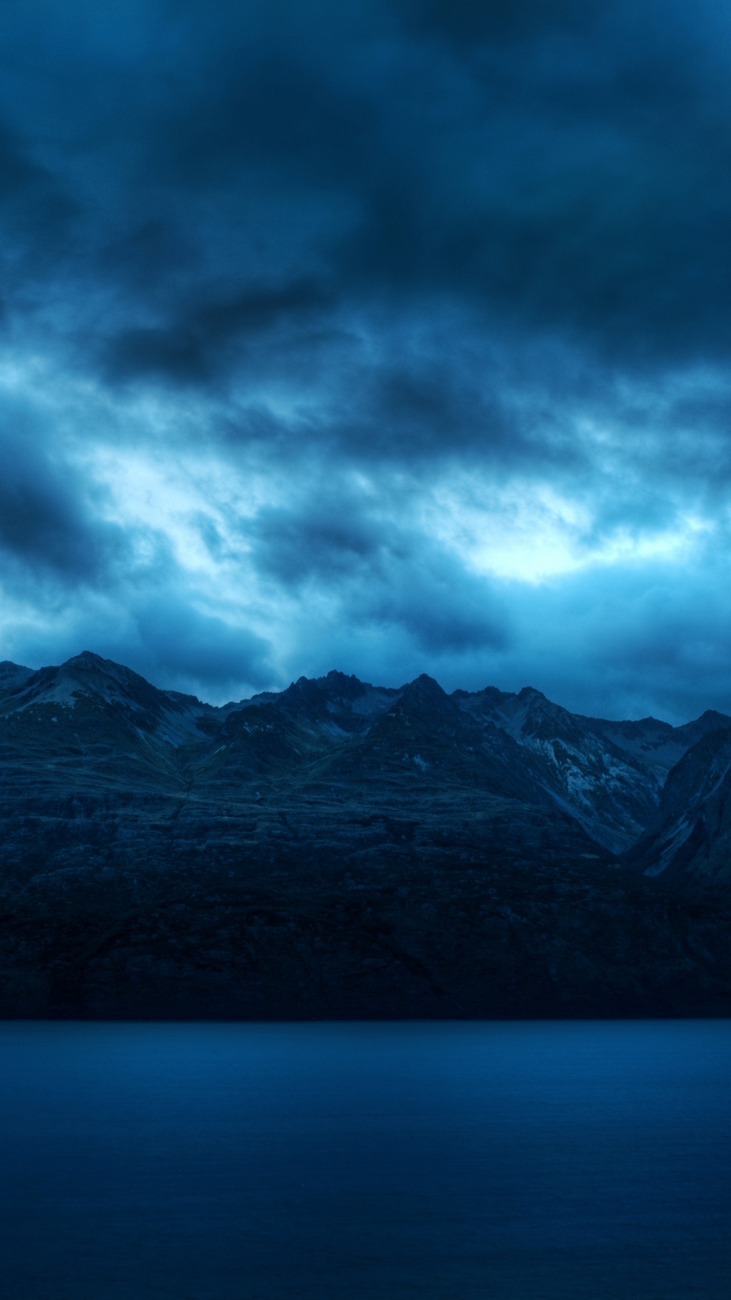 Black and White Mountains Under Gray Clouds. Wallpaper in 1440x2560 Resolution